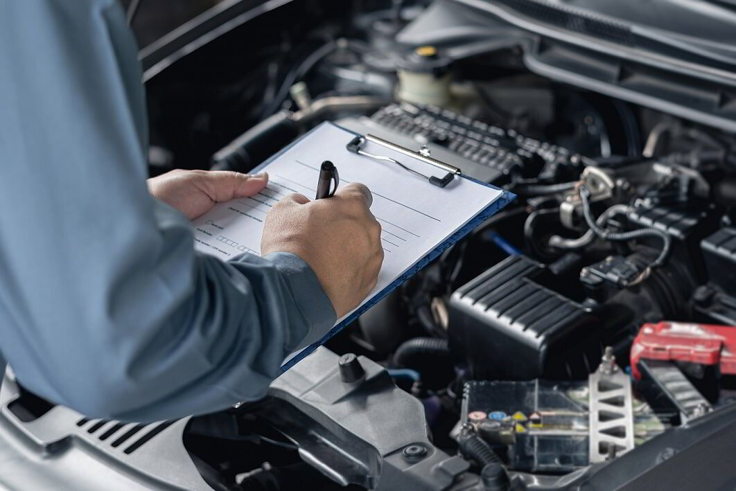 Fleet service technician completing a vehicle inspection checklist